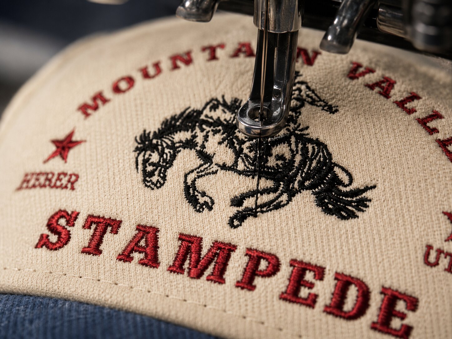 Custom embroidery being applied to a western hat