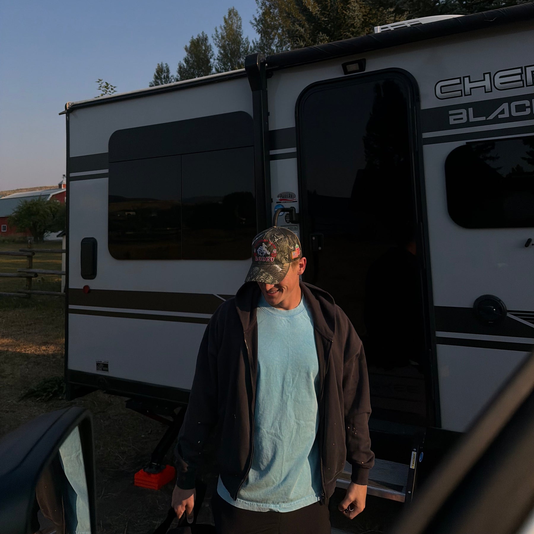 Loud Face cap worn beside a truck