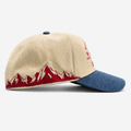 Mountain Valley Stampede ivory and denim trucker hat side view with mountain embroidery