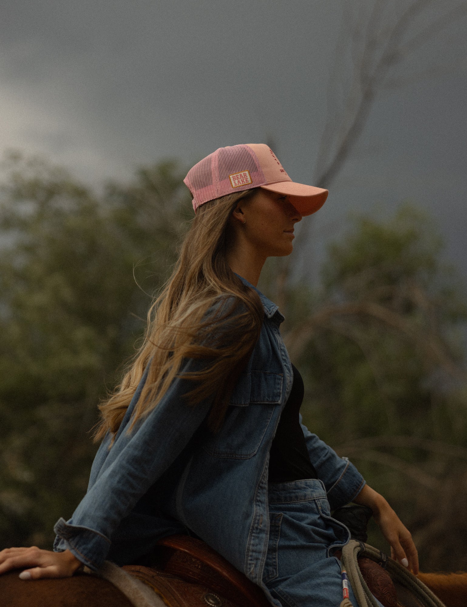 Portrait in a denim jacket and Loud Face rodeo cap
