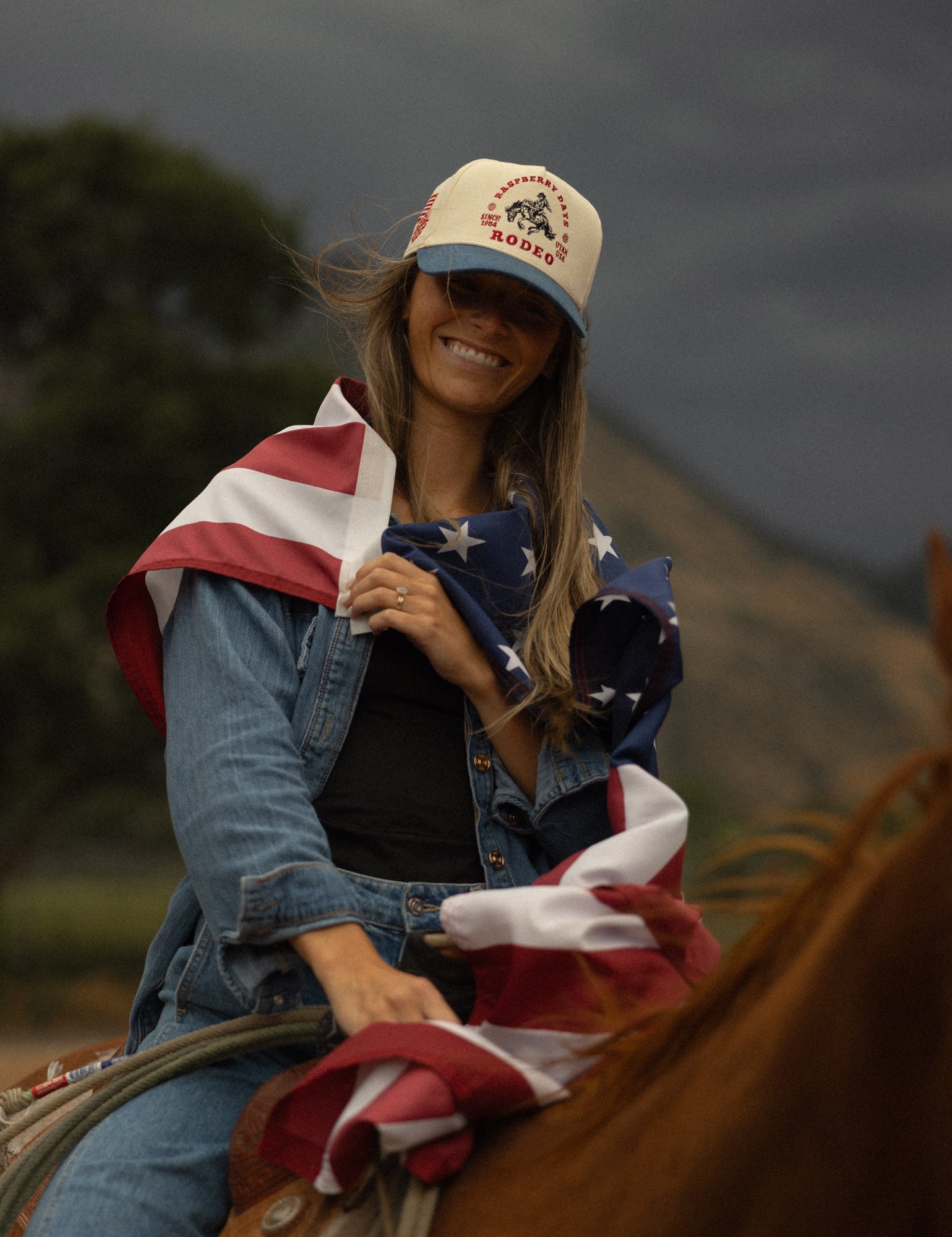 Rider draped in an American flag wearing a Loud Face cap