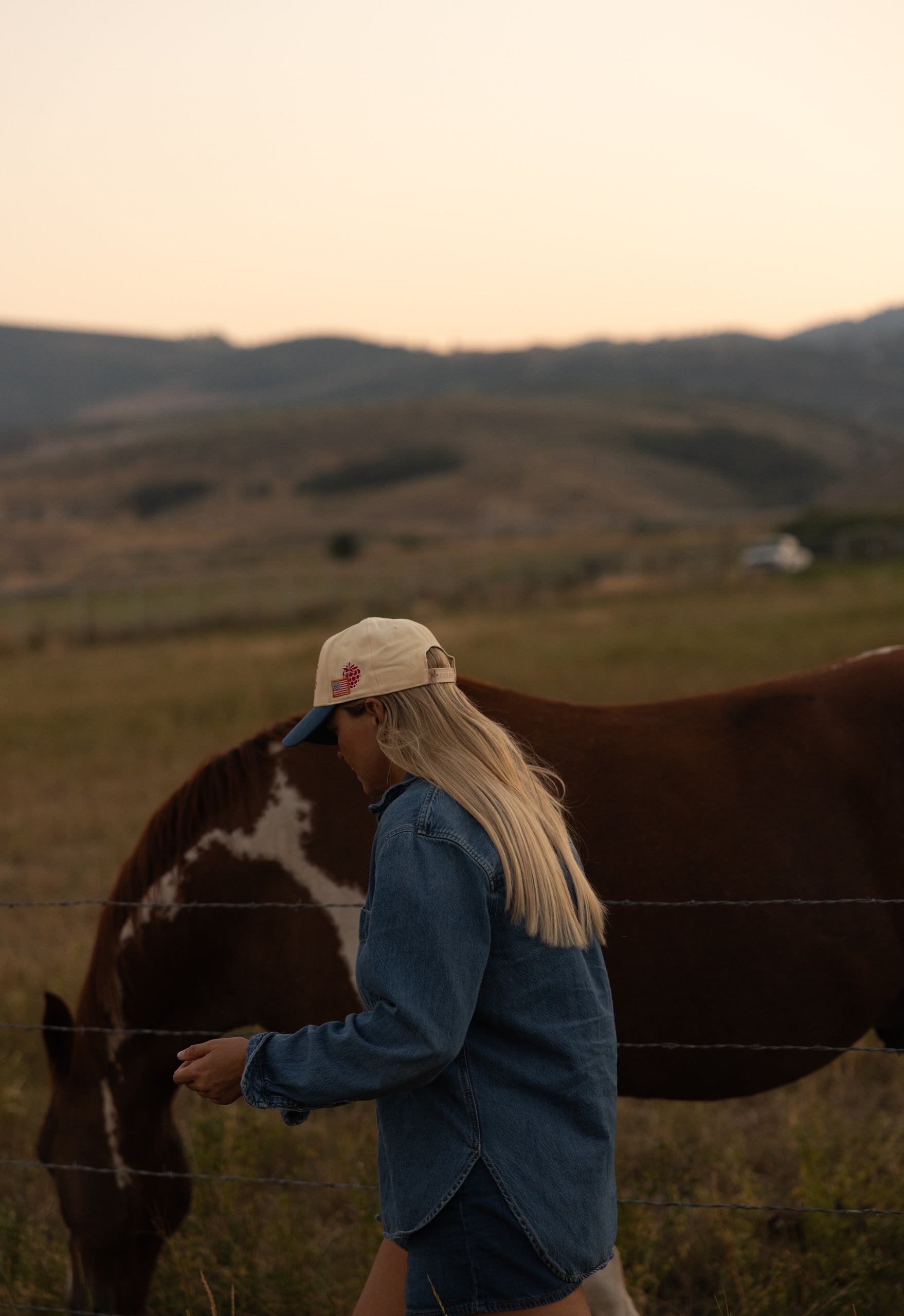 Rider with a horse at golden hour wearing Loud Face Supply